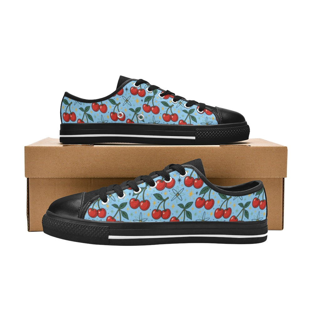 Atomic Cherries Kids Sneakers(B) in black and cherry print displayed on a shoebox.