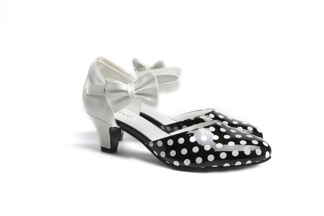 SugarPOP Spotted – Playful black and white kitten heels with a heart-shaped buckle and removable bow, perfect for retro vibes.