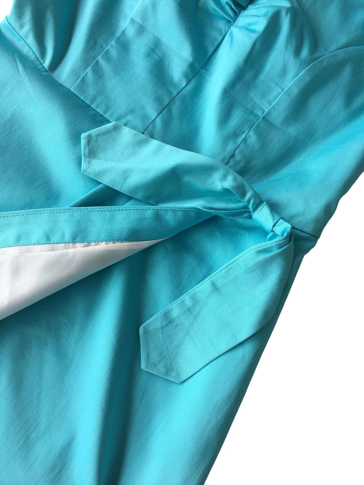 Close-up of a turquoise shirt with a pocket on a white background