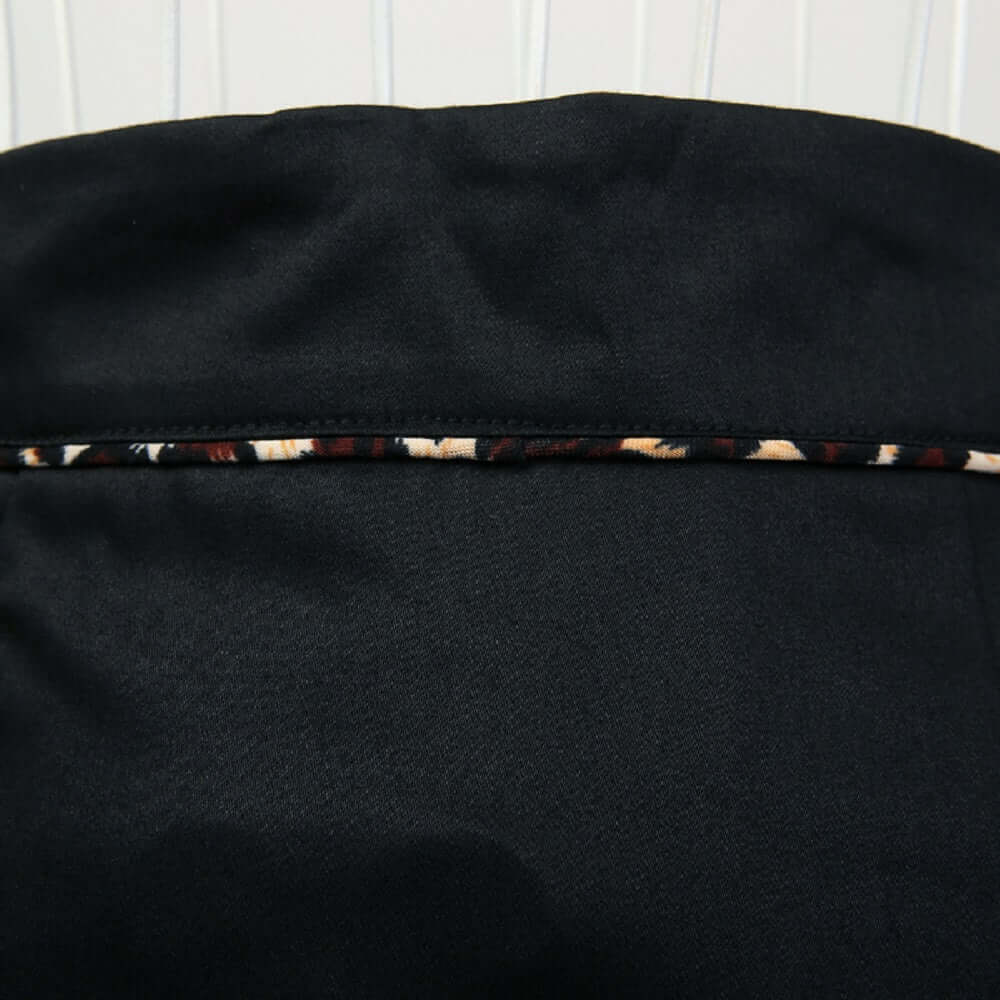 Close-up of the black pencil skirt showcasing leopard piping detail for a sophisticated look.