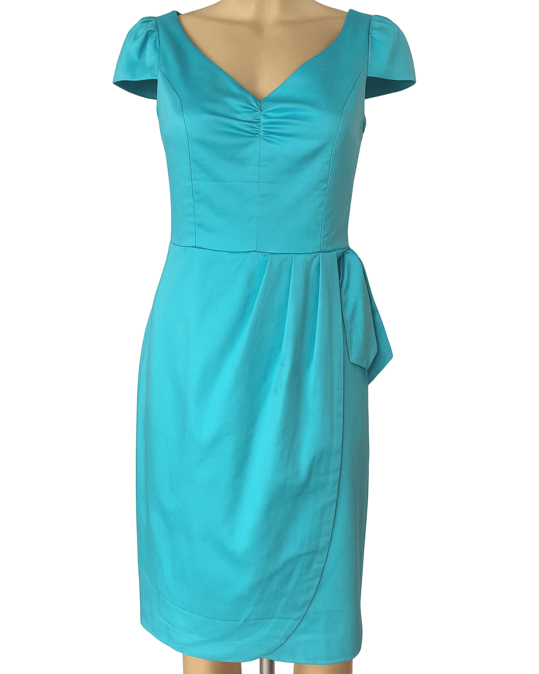 Turquoise dress on a mannequin against a white background