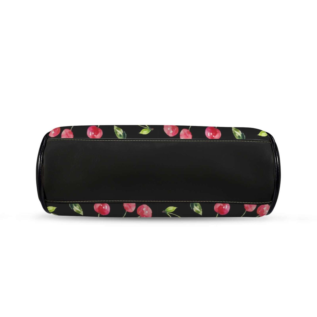Vintage handbag with cherry print on a black background, showcasing a kisslock design for a playful retro accessory.