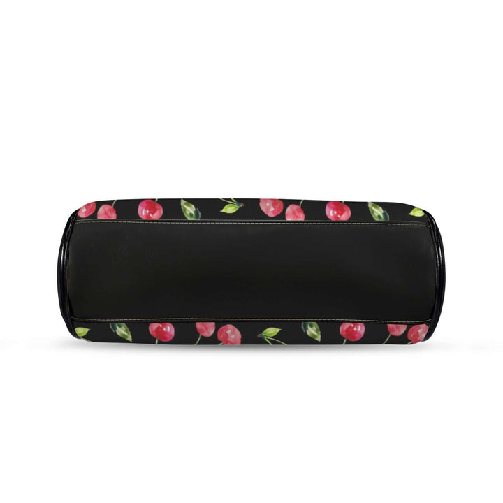 Vintage handbag with cherry print on a black background, showcasing a kisslock design for a playful retro accessory.