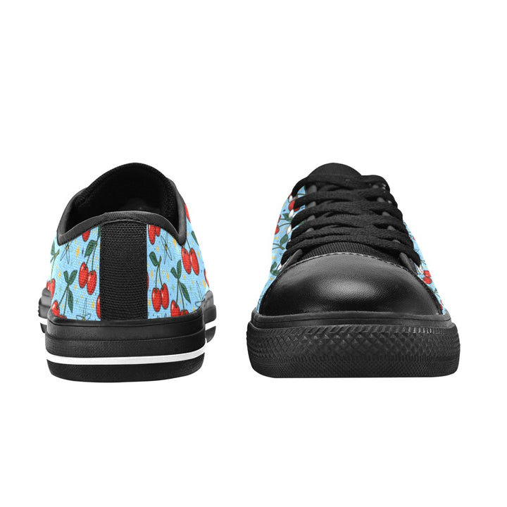 Atomic Cherries Kids Sneakers(B) featuring bright red cherries on a blue background with black accents and a sporty design.