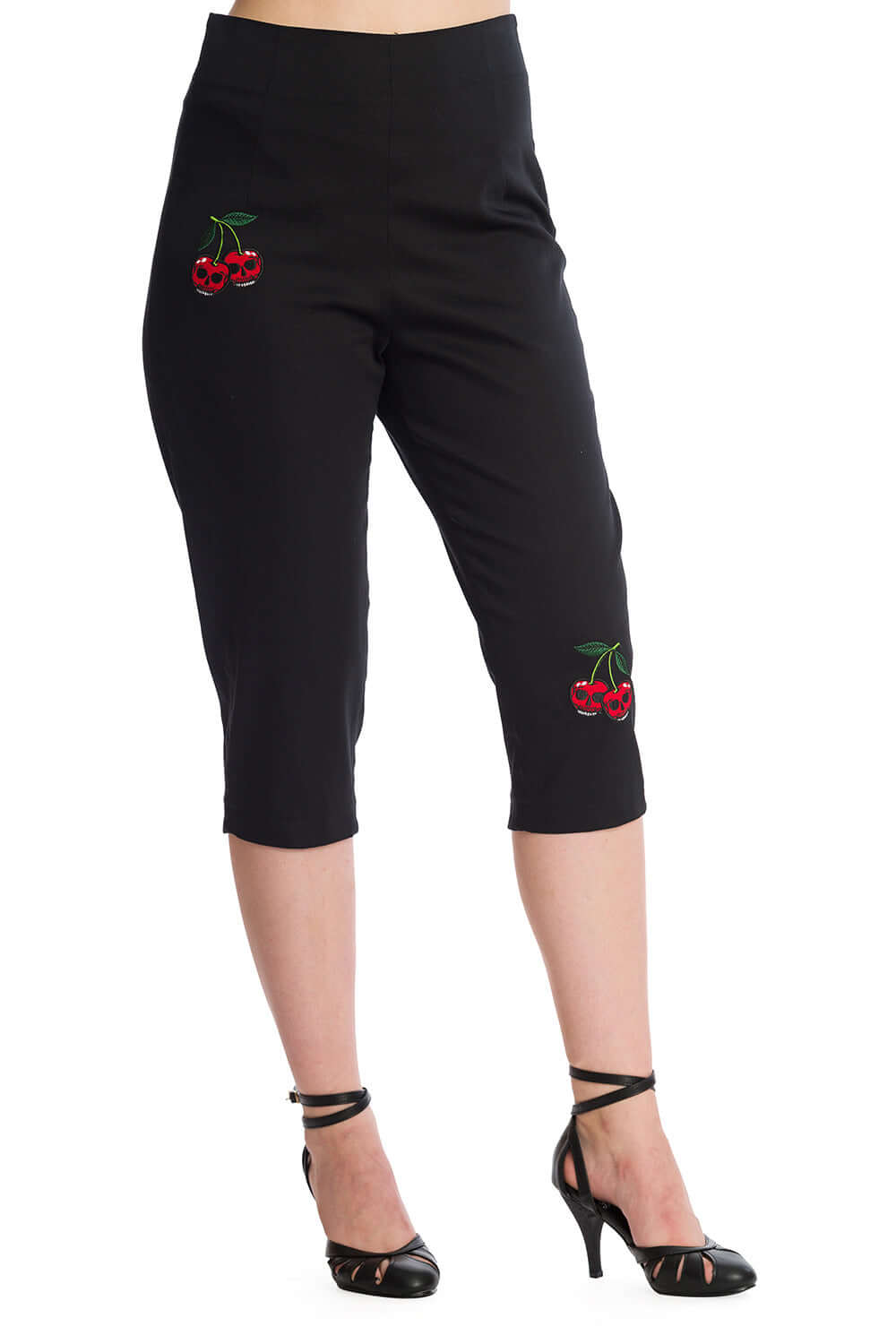 High-waisted black pedal pushers with cherry skull embroidery, styled with strappy heels for a rockabilly look.