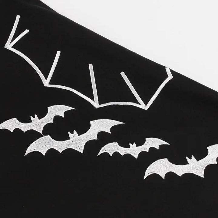 Bat Embroidered Vintage A-Line Halloween Dress featuring playful bat designs on a black fabric surface.