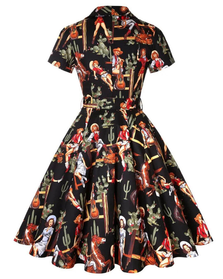 Vintage black western cowgirl swing dress featuring a colorful pinup print with cacti and guitars.