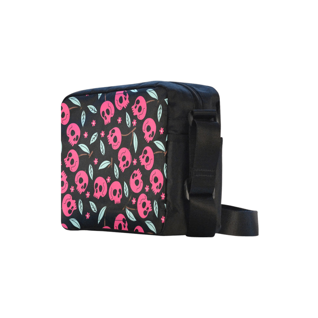 Cherry Skulls Crossbody Bag featuring vibrant pink skulls and leaves on a sleek black background, perfect for edgy style.