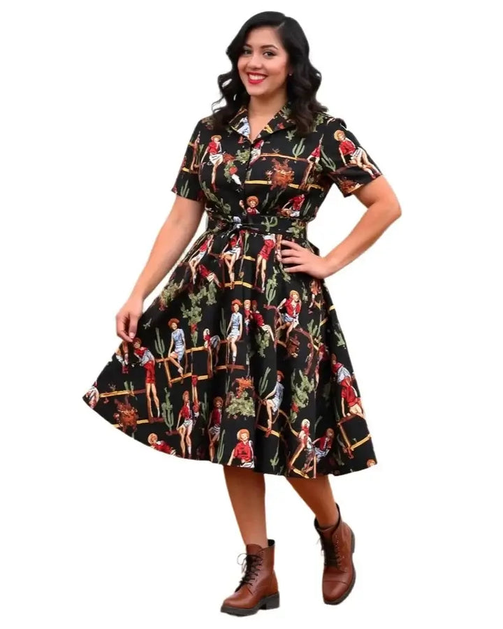 Woman wearing a Tropical Pinups Black Western Cowgirl Swing Dress with vintage print and western motifs.