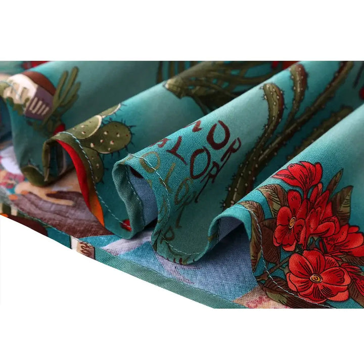 Close-up of colorful fabric featuring vibrant floral and cactus prints inspired by Frida Kahlo's artwork.