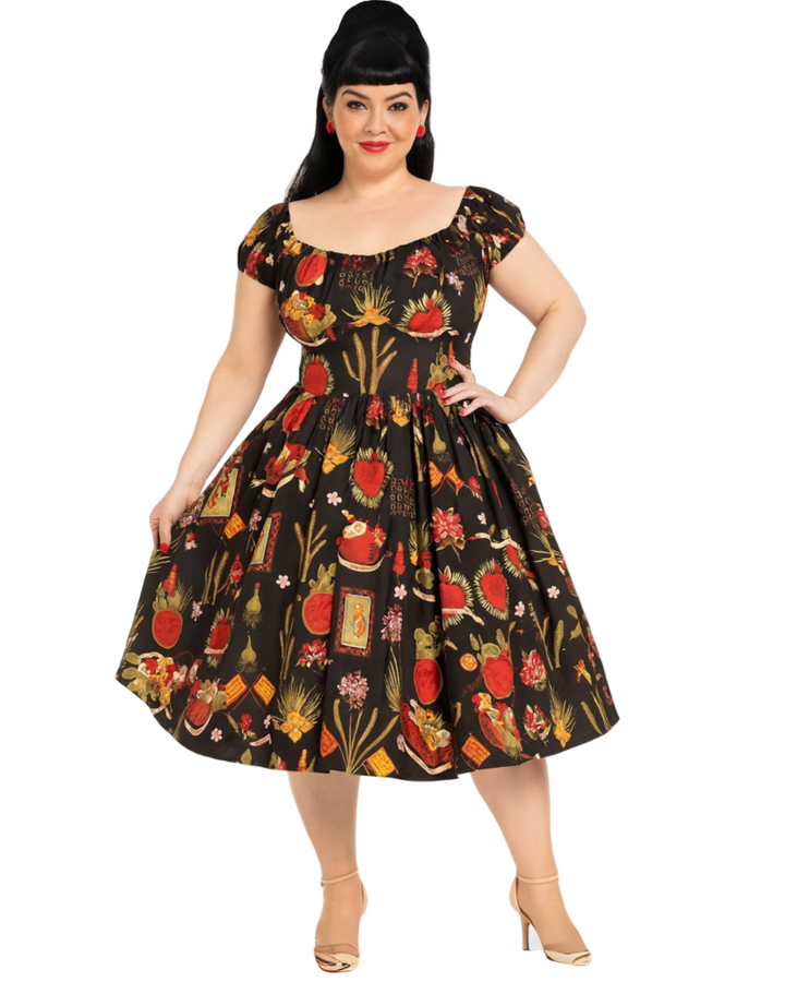 Woman wearing a vintage-style dress with a colorful pattern on a white background