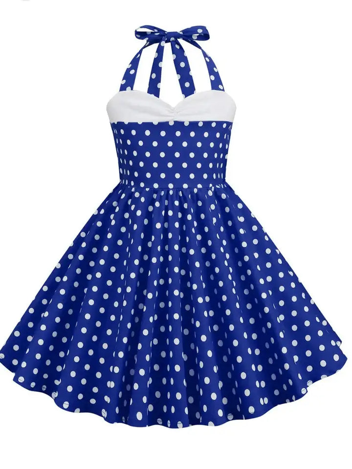Girls blue polka dot halter rockabilly dress with A-line silhouette and knee-length style, perfect for fun twirling occasions.