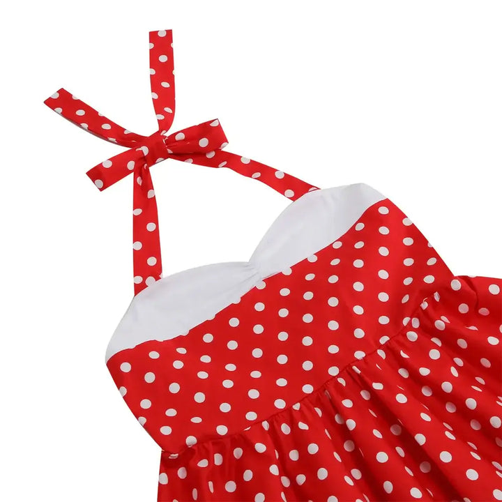 Girls red polka dot halter dress showcasing playful design with stylish ties and A-line silhouette.