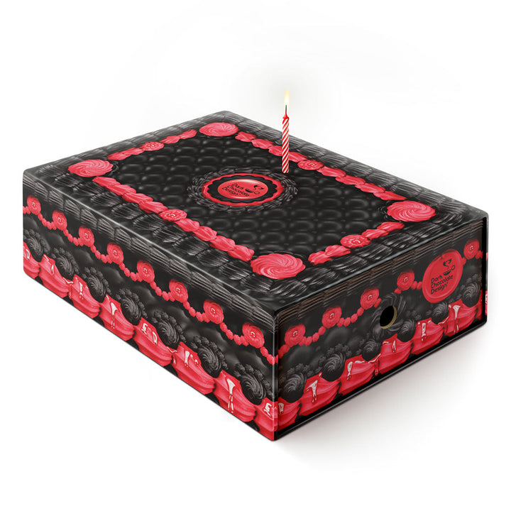 Hot Chocolate Design - Angel & Demon MidHeel displayed in a decorative box with red accents and a single candle on top.