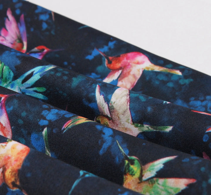 Close-up of Hummingbird Print fabric featuring colorful hummingbirds on a navy blue background for Sweetheart Halter A-Line Dress.