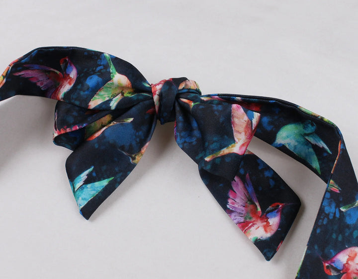 Hummingbird Print Sweetheart Halter A-Line Dress navy blue bow detail with vibrant hummingbird pattern.