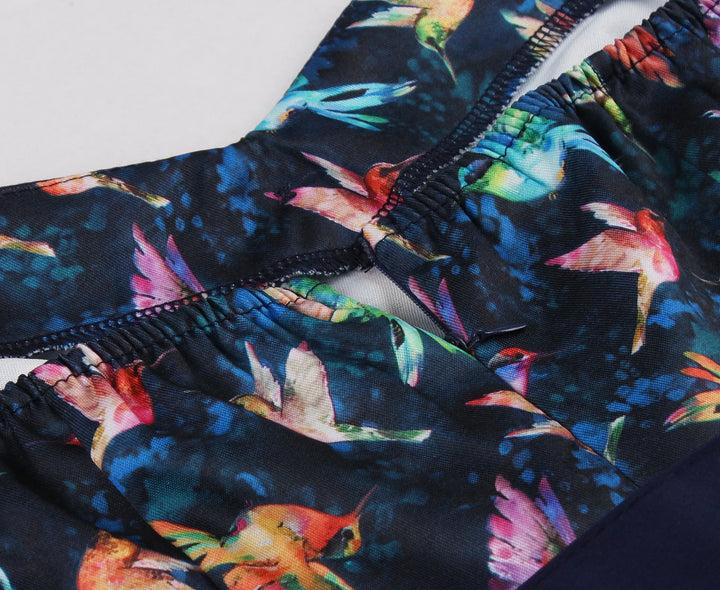 Hummingbird Print Sweetheart Halter A-Line Dress fabric detail featuring colorful hummingbird pattern on navy blue background.