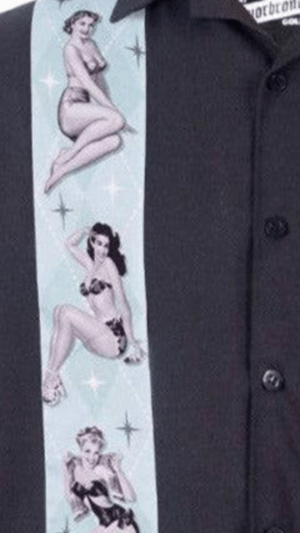 Close-up of the Liquorbrand Vegas Strip Bowling Shirt featuring Hawaiian hula girl print on a black crepe fabric.