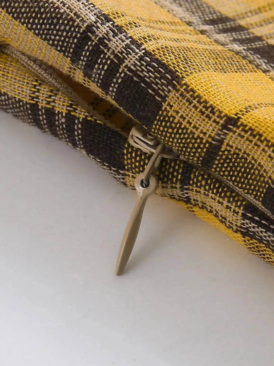 Close-up of the zipper detail on the Lucille plaid dress highlighting its chic yellow and black plaid fabric.
