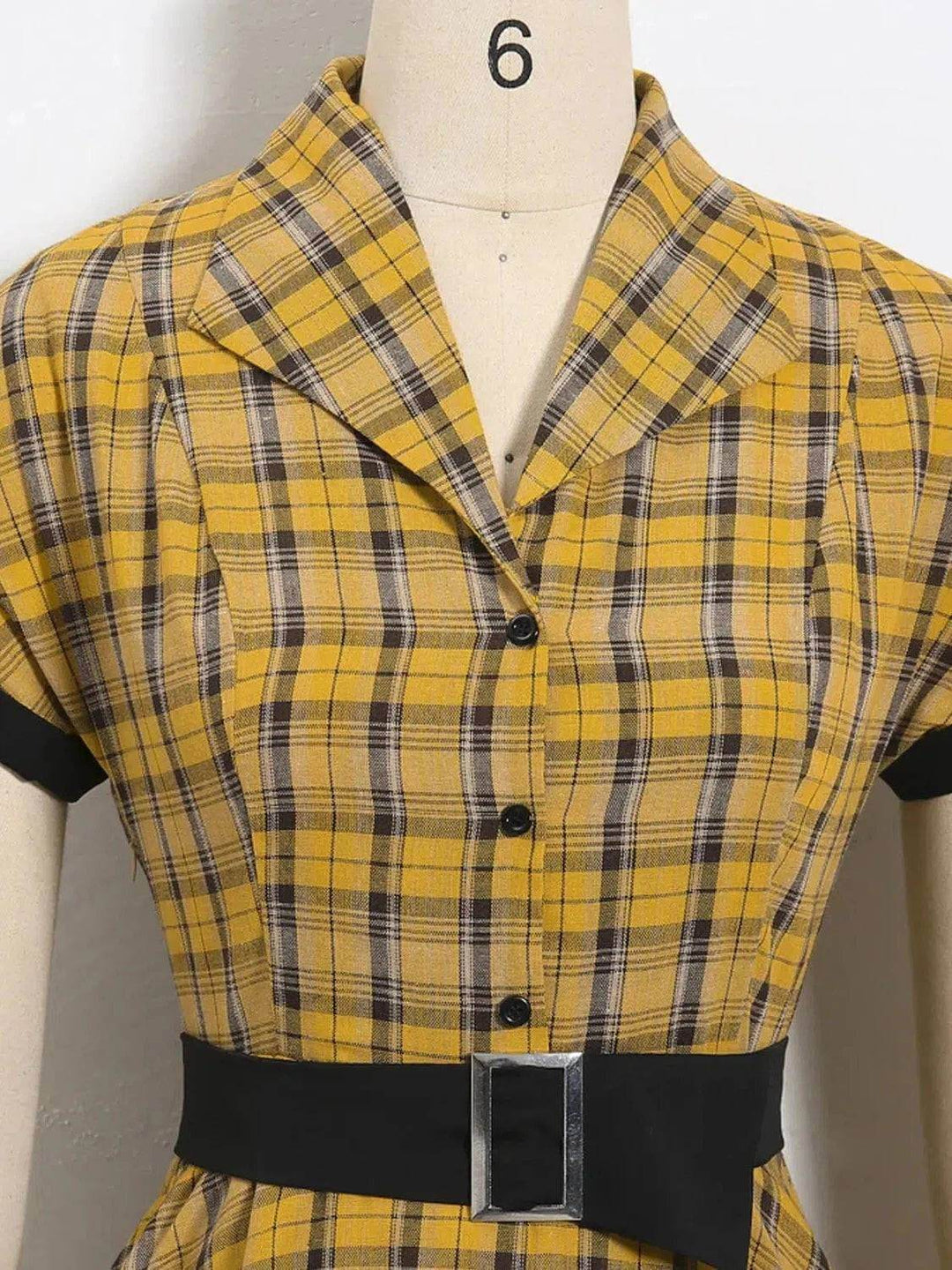 Close-up of Lucille Plaid Single Breasted 50s Dress showcasing yellow plaid fabric and stylish belt detail.