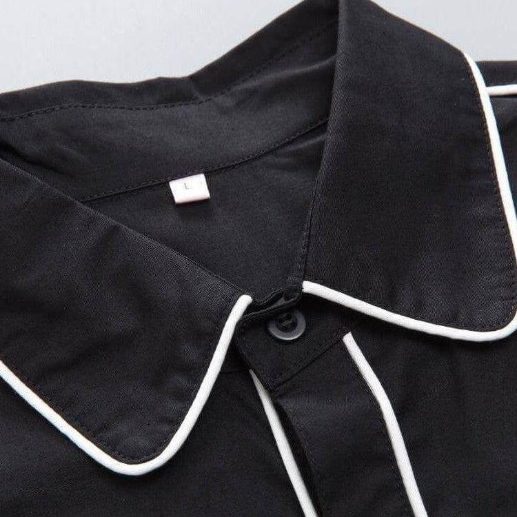Close-up of black men's western shirt collar with white piping and label size L, showcasing quality craftsmanship and detail.