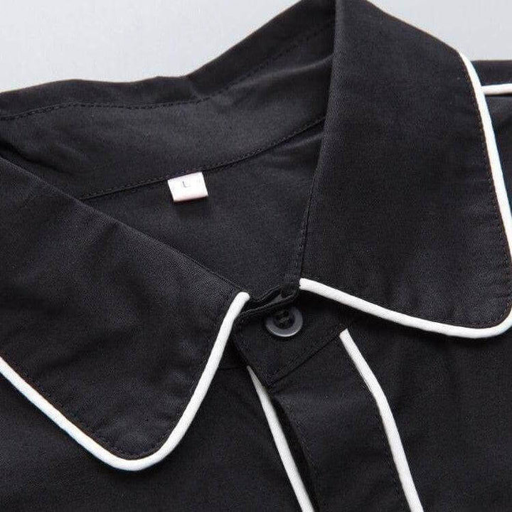 Close-up of black men's western shirt collar with white piping and label size L, showcasing quality craftsmanship and detail.