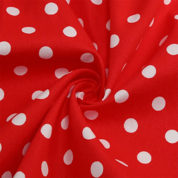 Close-up of red fabric with white polka dots, perfect for a girls' rockabilly dress design.