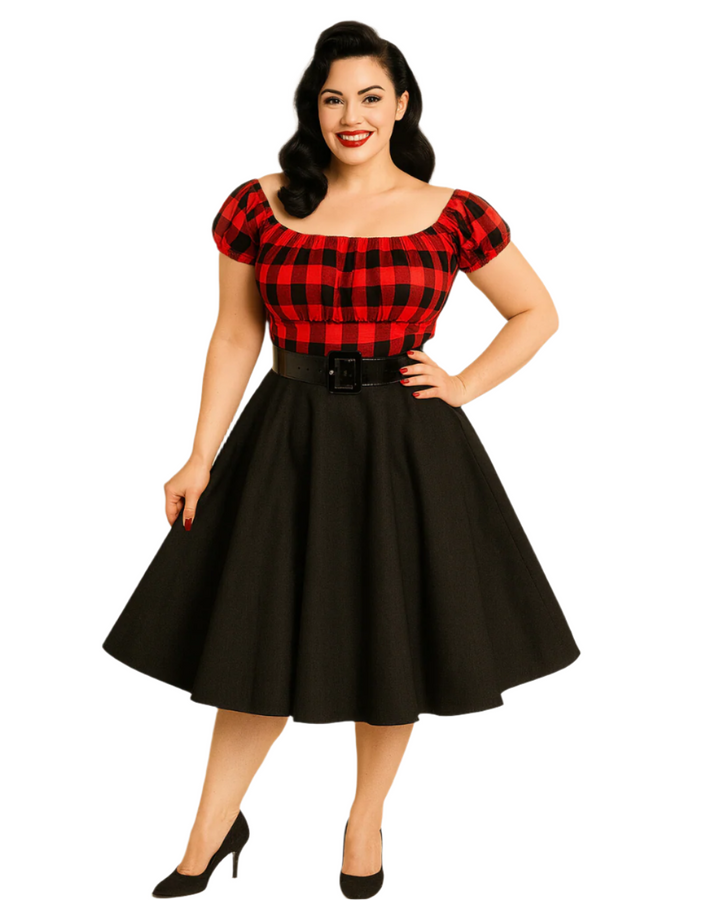 Woman wearing a red and black checkered top with a black skirt on a beige background