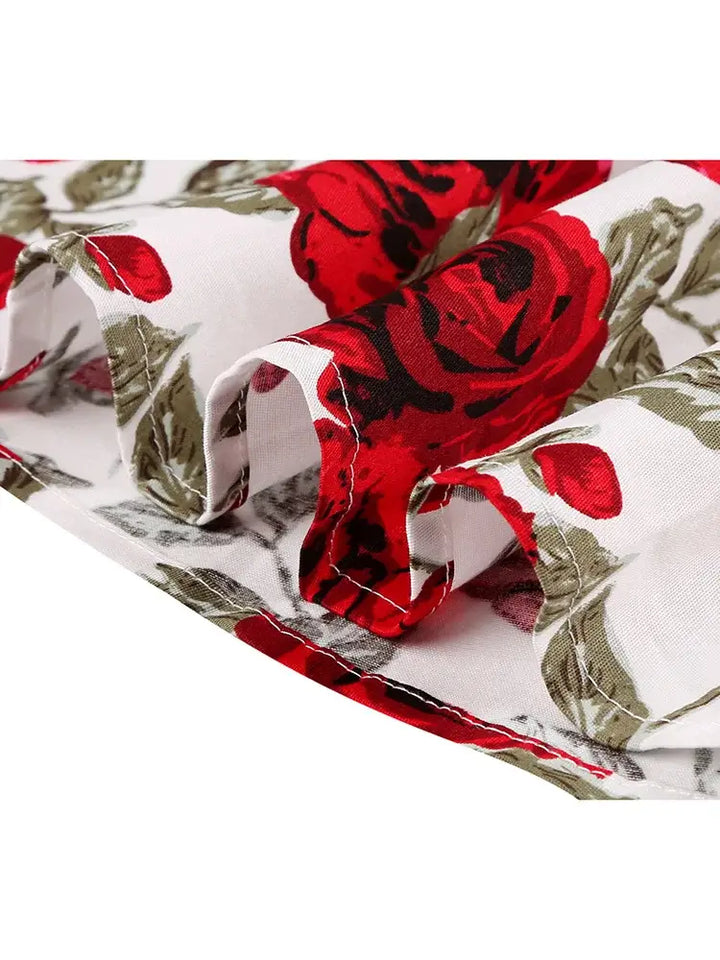 Close-up of red rose patterns on lightweight fabric for the Rose Romance Vintage Swing Dress.
