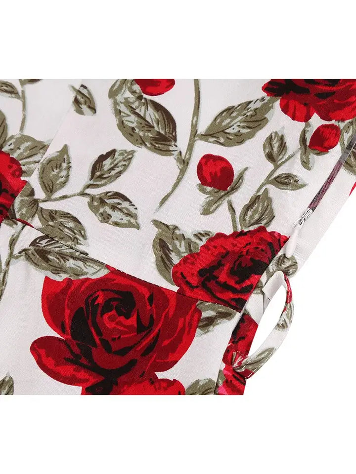 Detailed close-up of the floral pattern featuring red roses on a white background for Rose Romance Vintage Swing Dress.