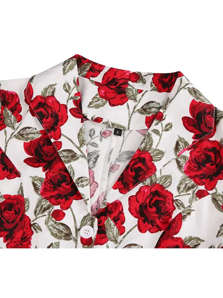 Close-up view of the Rose Romance Vintage Swing Dress collar with red rose print on a white background.