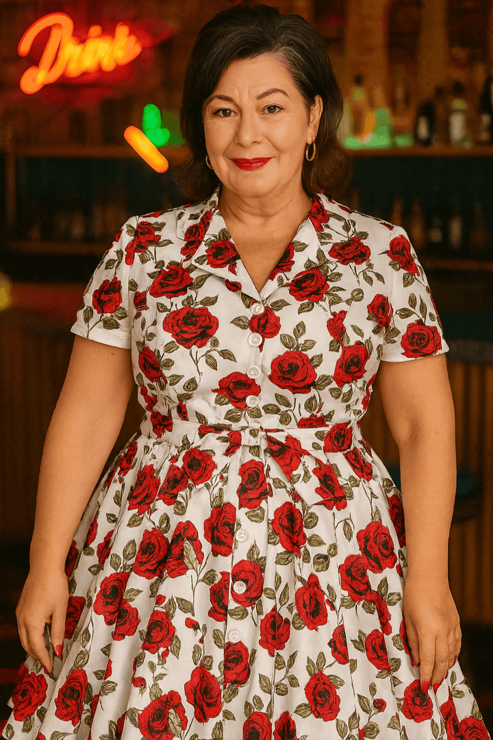 Woman in a Rose Romance Vintage Swing Dress featuring red floral print, standing confidently in a lively bar setting.