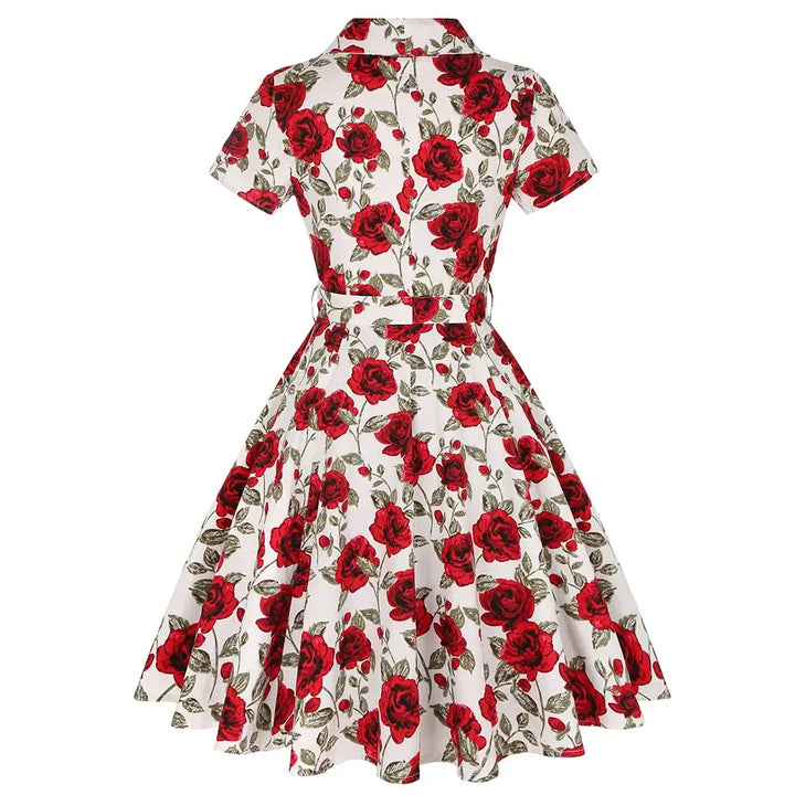 Back view of Rose Romance Vintage Swing Dress with red roses on a white background, showcasing its elegant design.