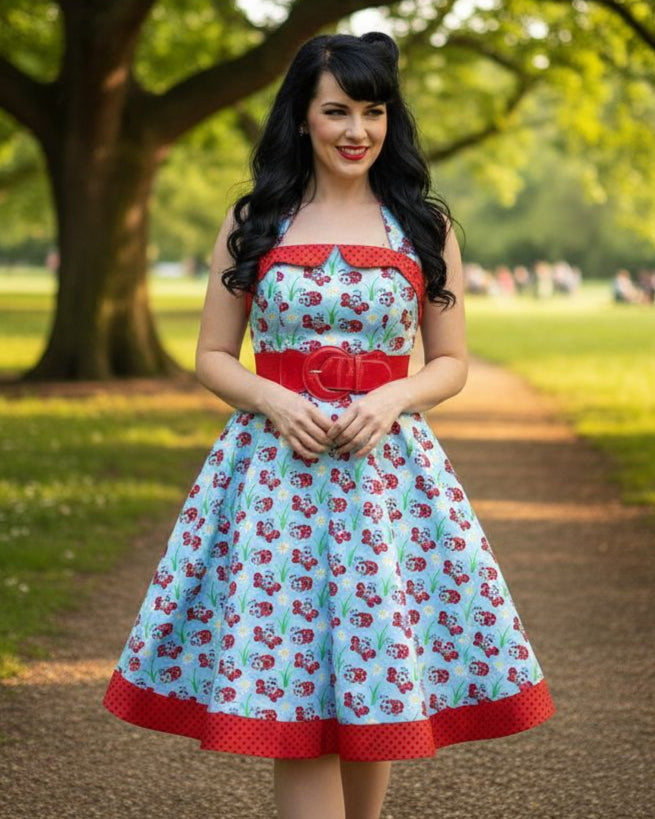 Woman in a ladybug patterned dress standing in a park