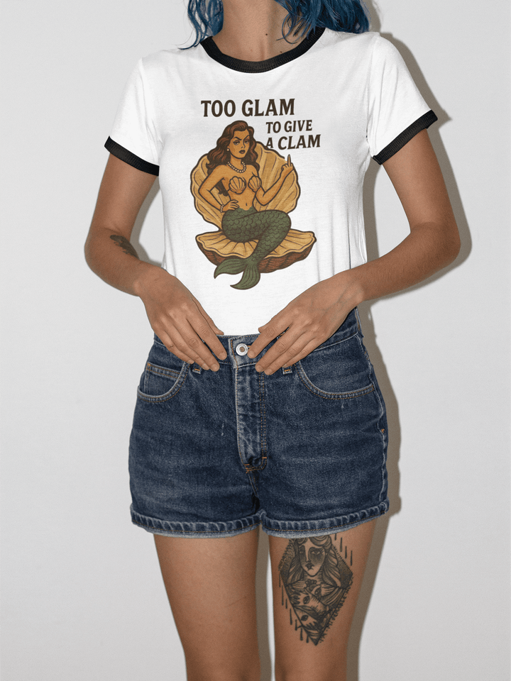 Model wearing Too Glam to Give a Clam women's ringer tee with a mermaid graphic, showcasing beach style.