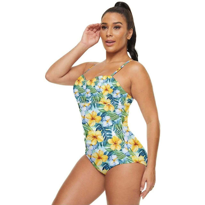 Woman modeling a Tropical Hibiscus full coverage swimsuit with vibrant floral print, perfect for beach days.