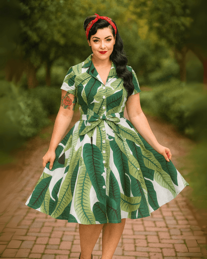 Model wearing the Tropical Leaves Vintage Swing Dress, featuring a vibrant tropical leaf pattern and a flattering silhouette.