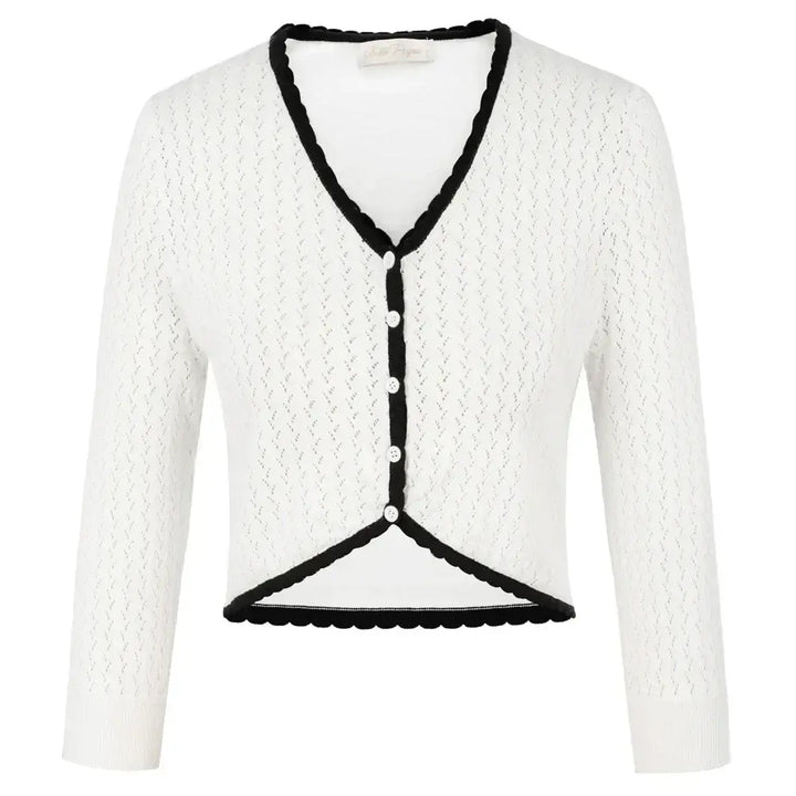 Vintage-inspired white knit bolero with V-neckline and 3/4 sleeves, featuring black trim and buttons.
