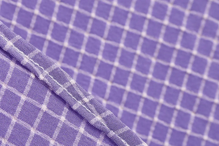 Vintage Lavender Halter Swing Dress with Pockets textured fabric close-up, featuring a white check pattern.