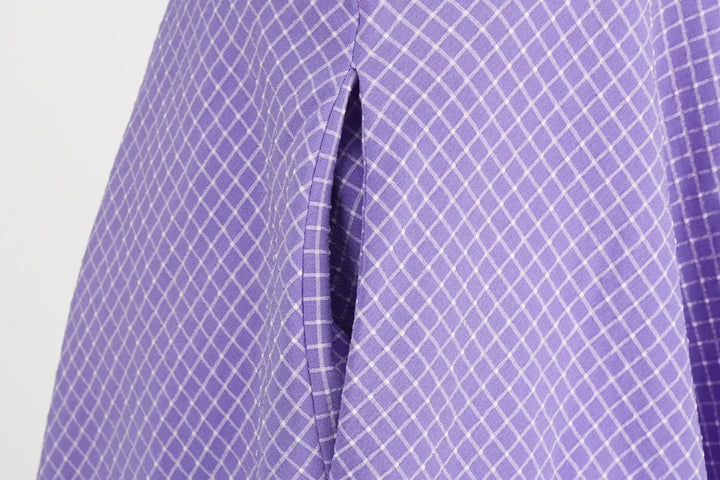 Vintage Lavender Halter Swing Dress with Pockets close-up showing pocket detail and textured lavender fabric.