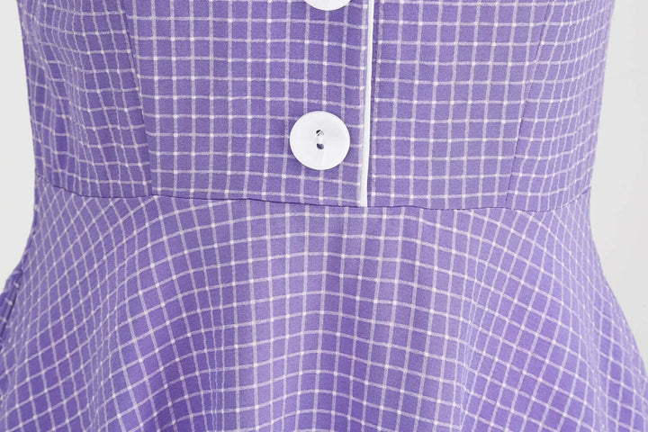Detail of Vintage Lavender Halter Swing Dress with Pockets showing buttons and lavender check pattern.
