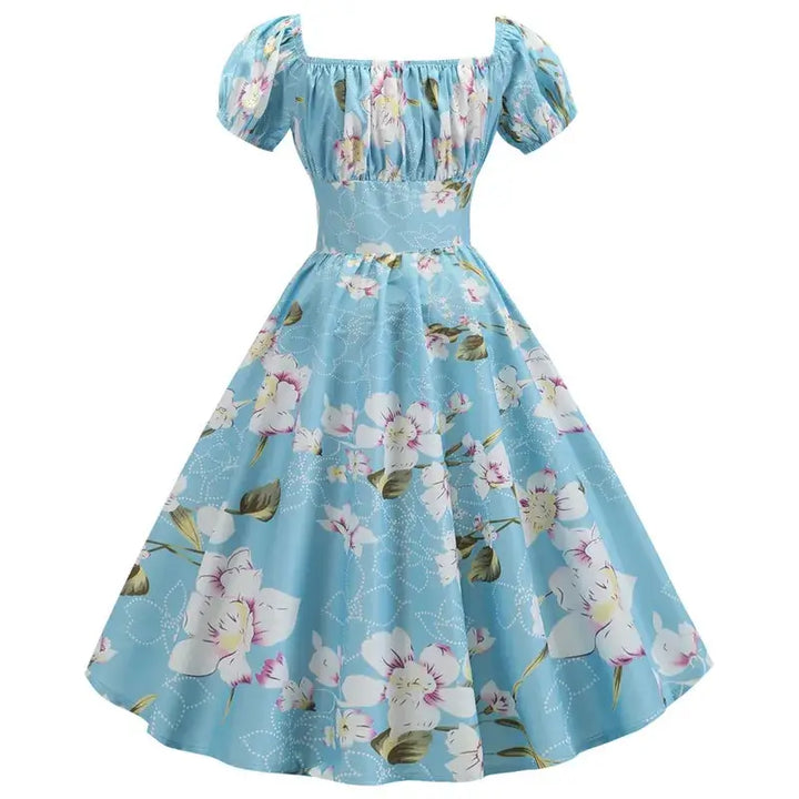 Vintage Peasant Style Blue Floral Dress featuring a square neckline and puff sleeves, adorned with a floral pattern.