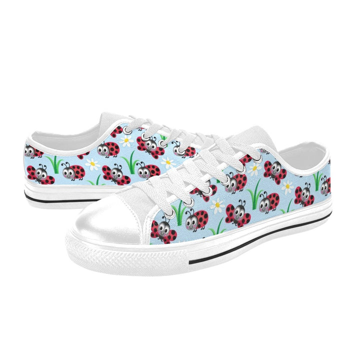 White sneakers with ladybug pattern on a light blue background