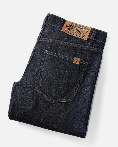 Folded Liquorbrand Rumbler Denim men’s jeans showing leather brand patch