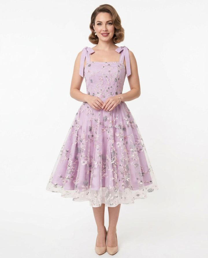 Woman wearing a purple floral dress on a white background