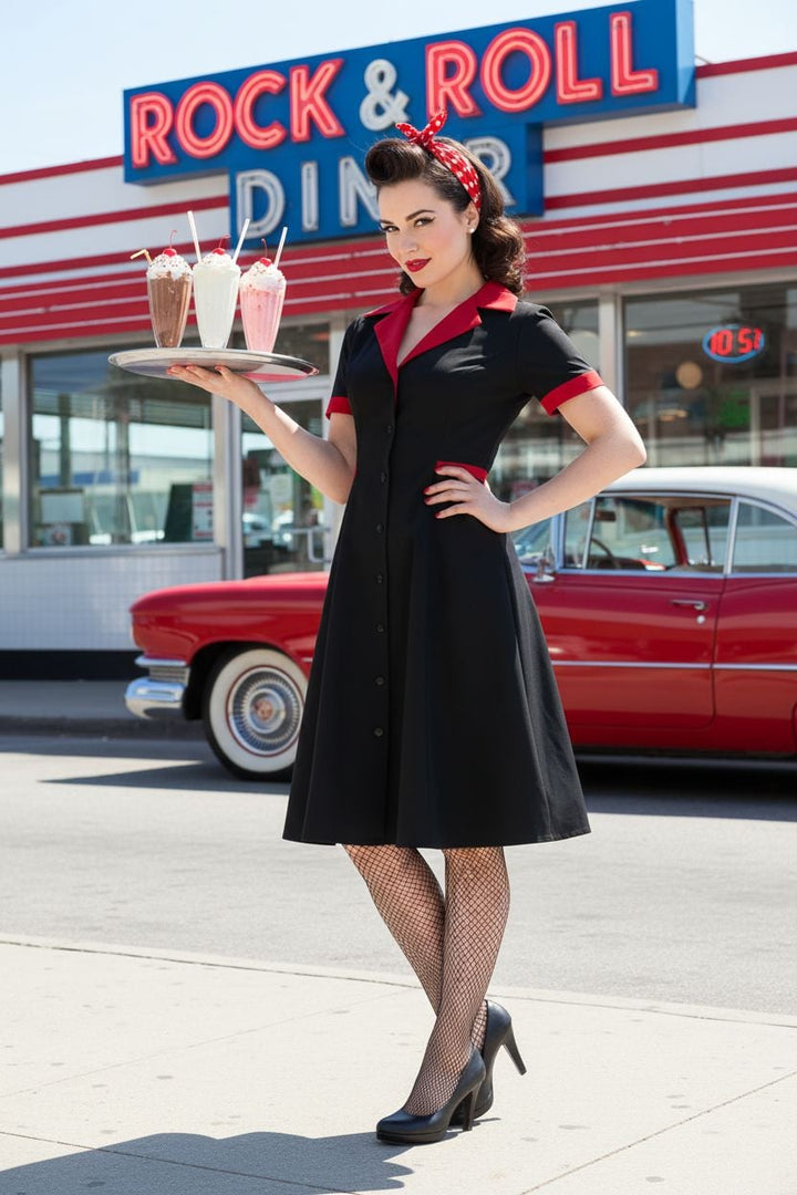 Woman in a black and red dress holding a tray with drinks in front of a Rock & Roll Diner.