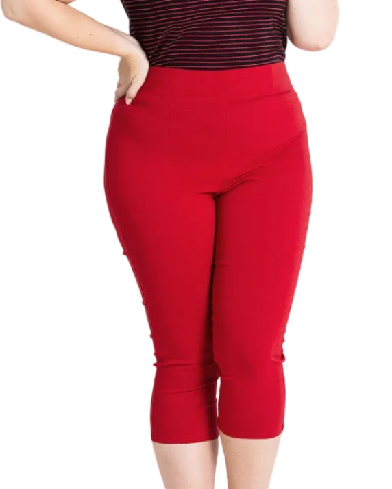 Red capri pants worn by a person on a white background