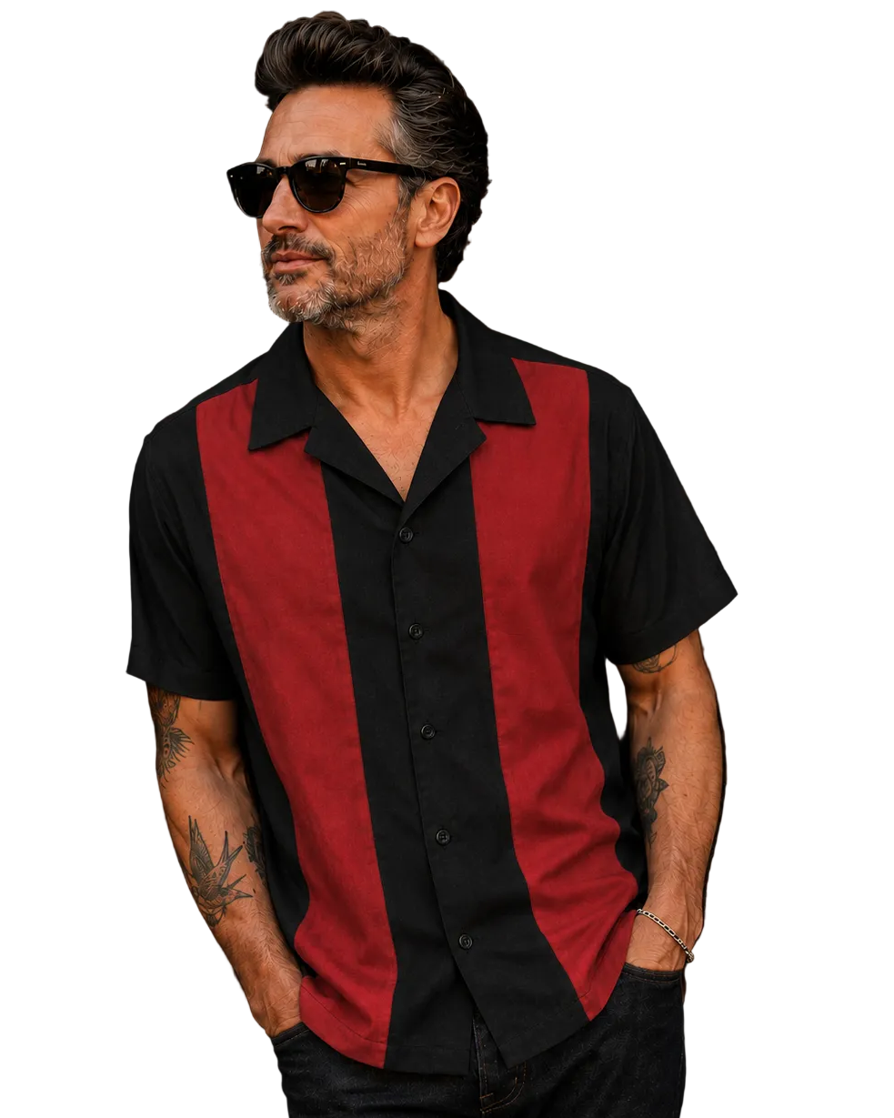 A man wearing a short-sleeve button-up shirt with a black base and bold red vertical panels, paired with black pants and sunglasses, against a plain white background.