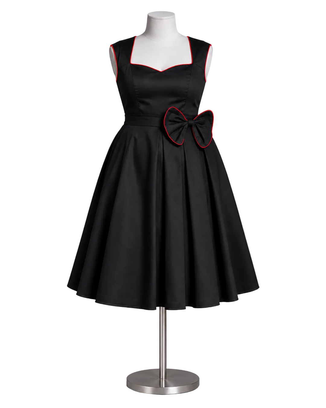 A black sleeveless fit-and-flare dress with a sweetheart neckline, red piping trim, and a large matching bow at the waist, displayed on a mannequin against a gray studio background.