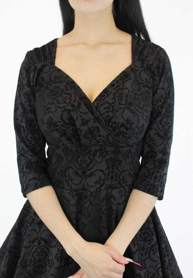 Black midi dress with three-quarter sleeves and pockets